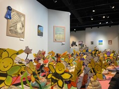 Colorful student artwork fills the temporary exhibit gallery